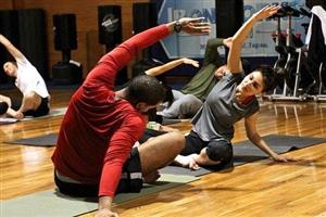 Men and women stretching in exercise room